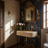 Beige travertine fluted sink with hand-carved stone detailing, mounted on a sleek black metal console stand.