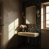 Beige travertine fluted console sink crafted from hand-carved stone with a sleek black metal stand.