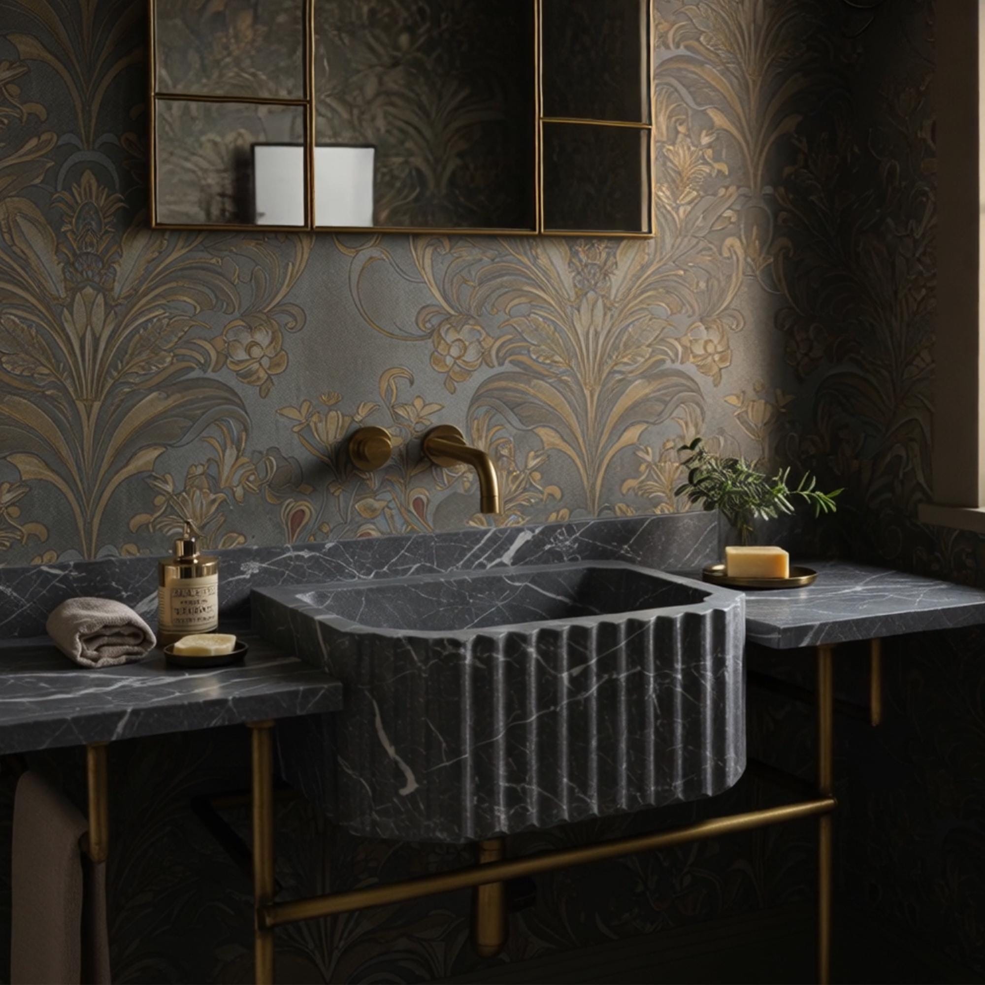 Hand-carved black marble console sink featuring fluted basin, integrated surface, and brass legs.