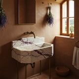 Calacatta Amber Viola marble octagonal sink with integrated backsplash and elegant brass console.