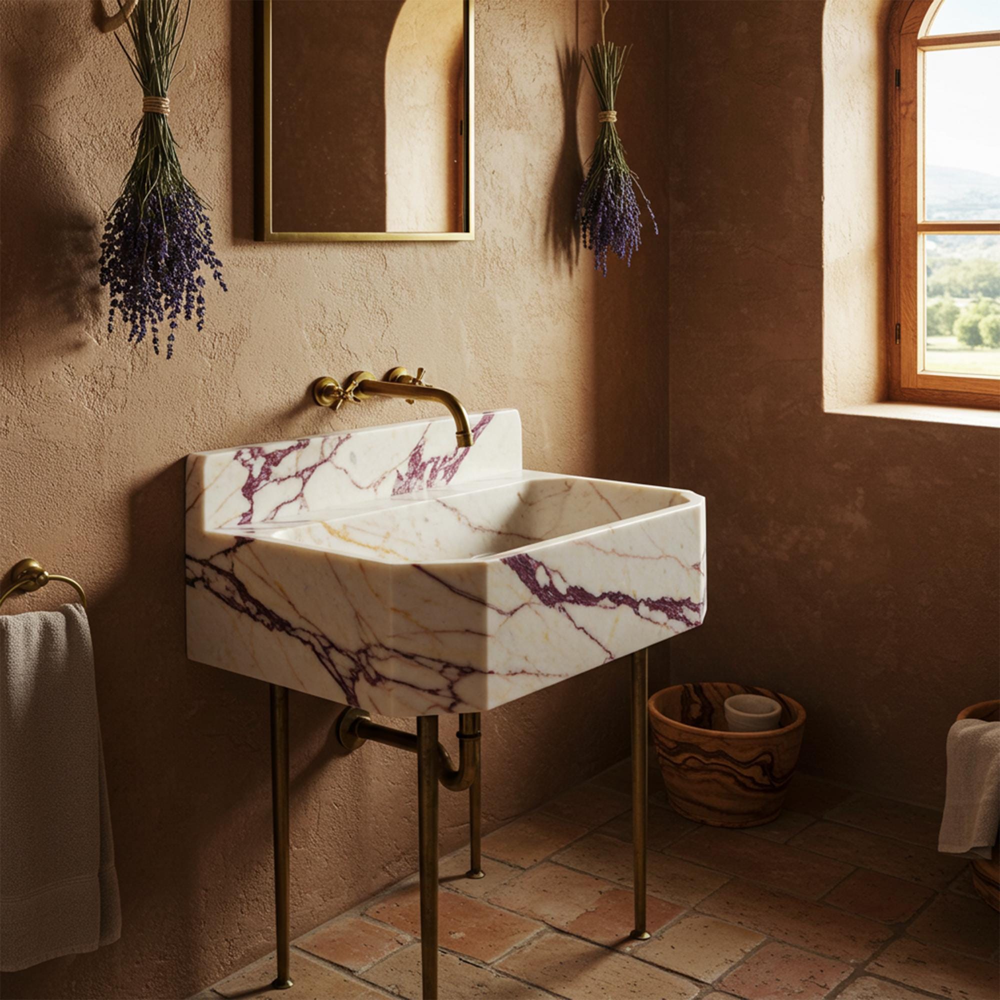 Calacatta Amber Viola marble vanity with brass legs and integrated stone backsplash.