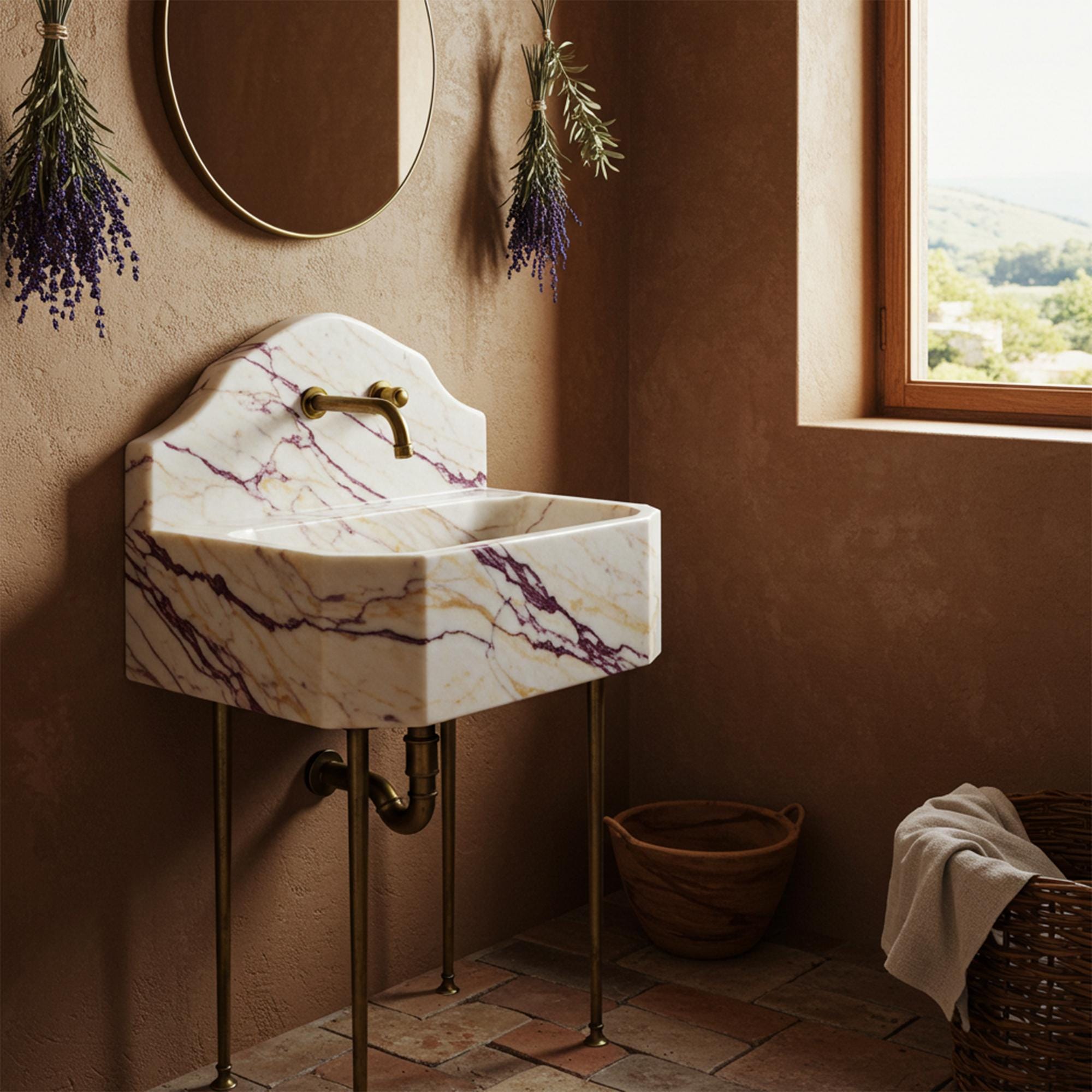 Calacatta Amber Viola marble sink with octagonal design, integrated backsplash, and brass console legs.