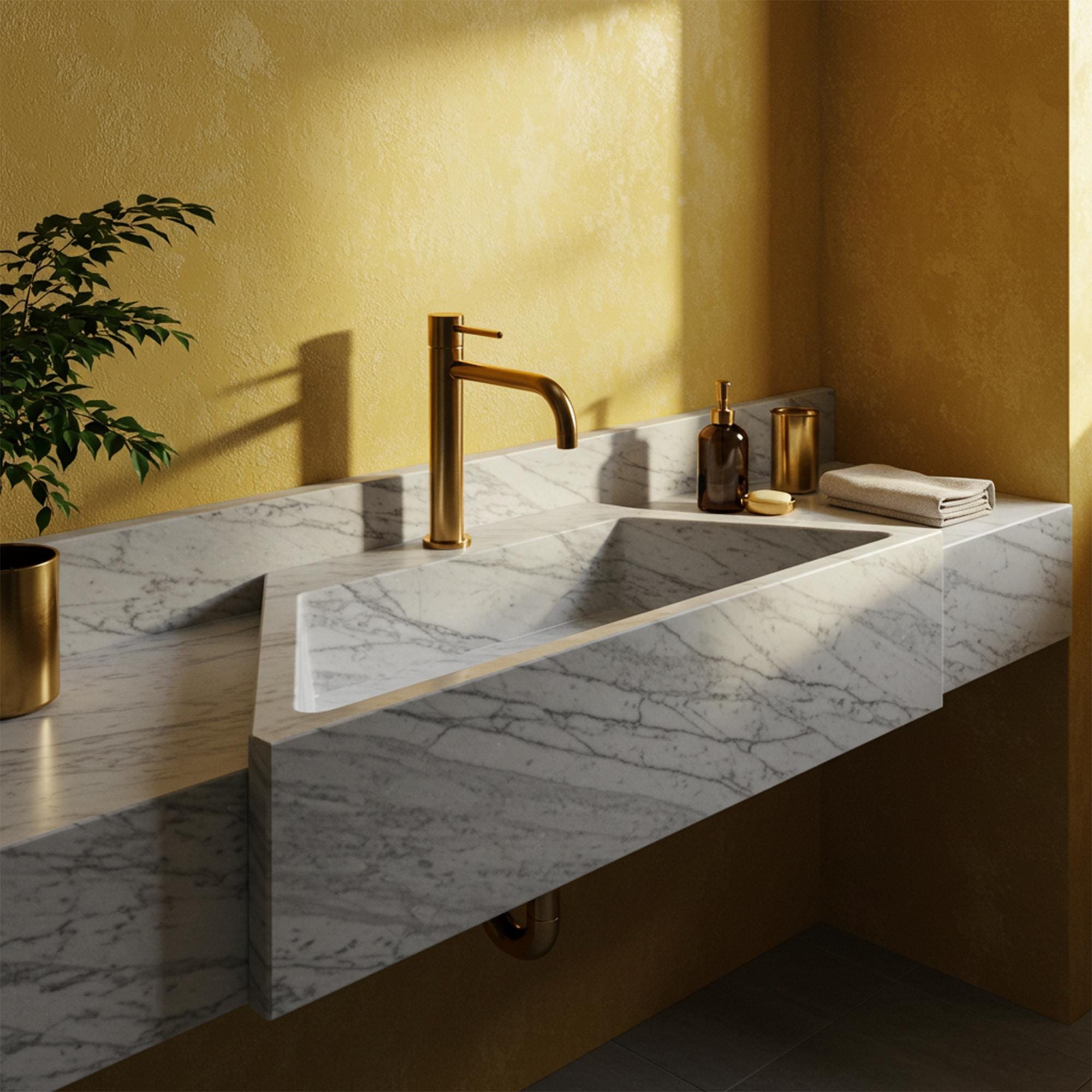 Carrara marble floating vanity sink with integrated backsplash and hand-carved stone design.