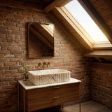 Carrara marble fluted vessel sink on walnut vanity in rustic farmhouse bathroom