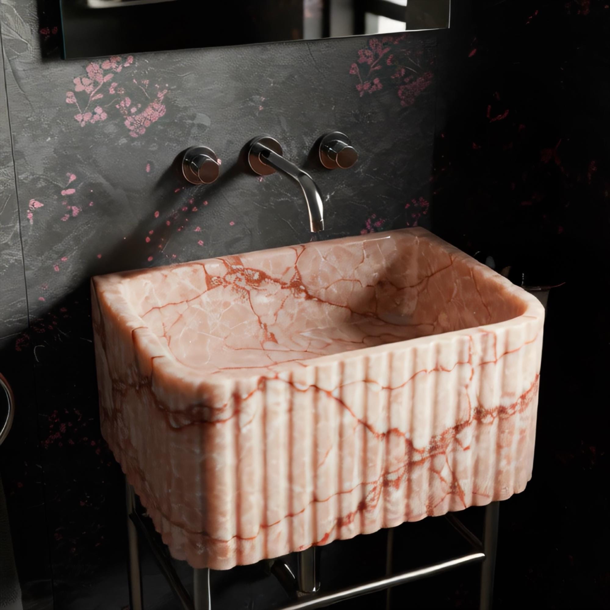 Compact console sink featuring vibrant pink marble and industrial-style metal base.