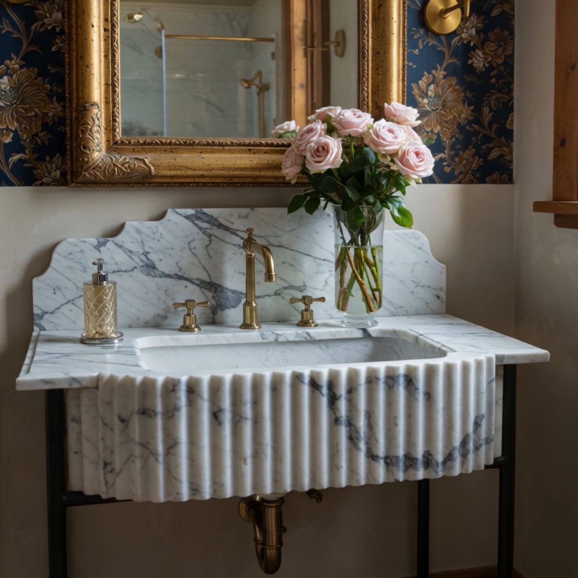 Elegant St. Moritz console sink with fluted Carrara-style marble basin, brass tapware, and decorative integrated backsplash design.