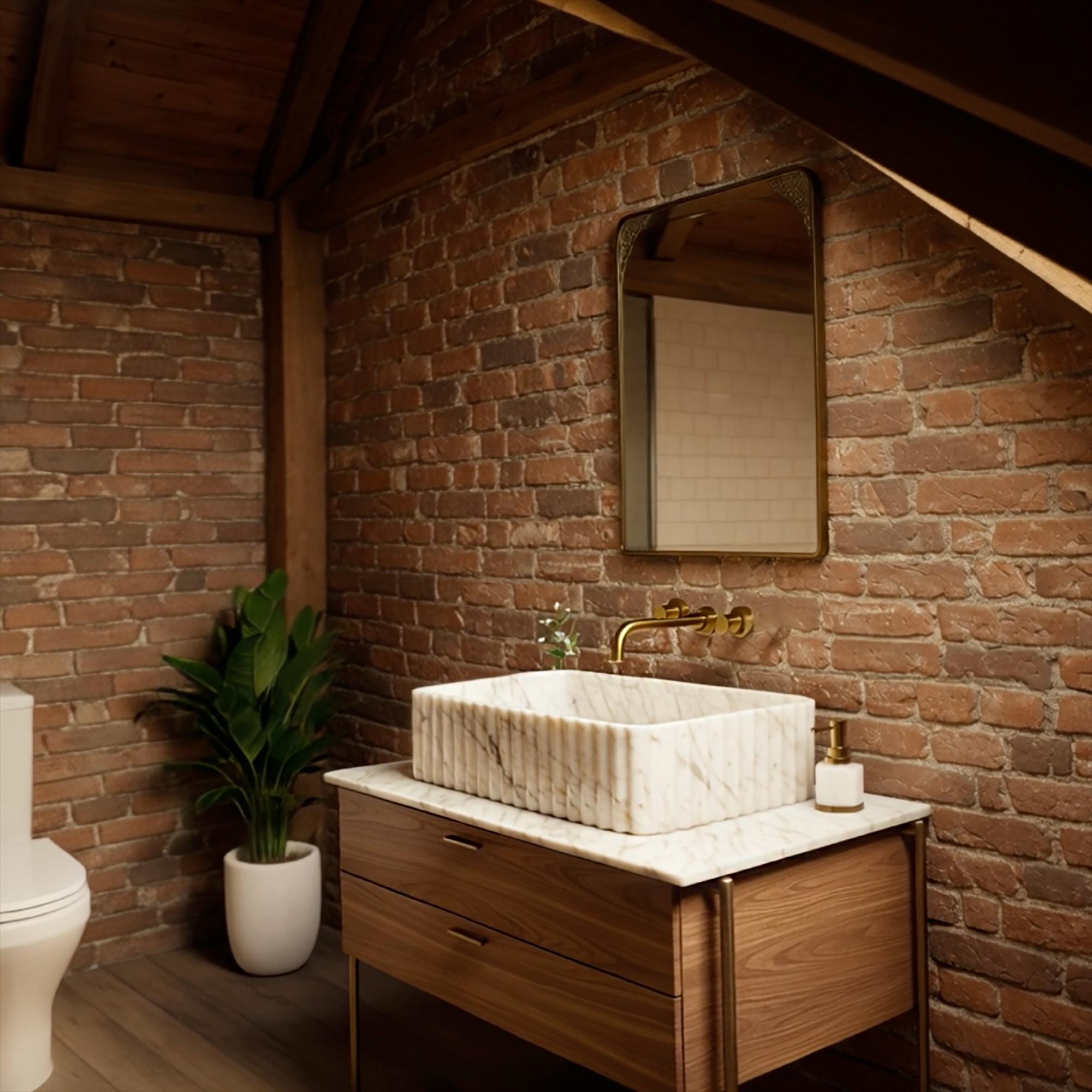 Elegant hand-carved fluted marble sink sitting atop a rustic wood vanity unit