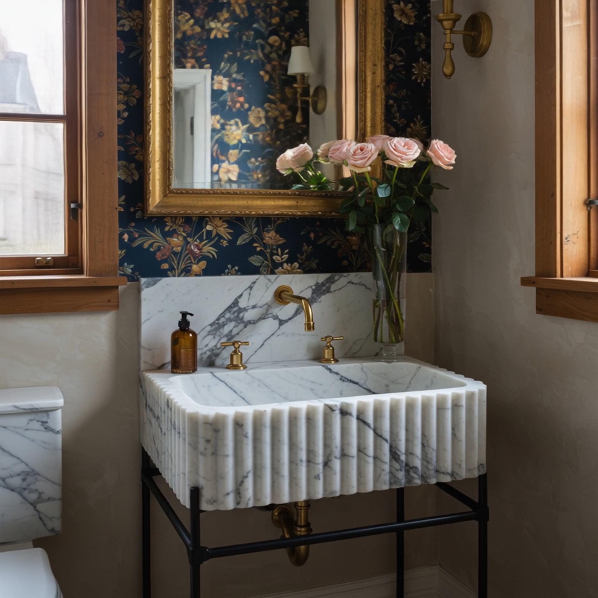 A luxury sink made of fluted Calacatta Viola marble, set atop a minimalist black console for artistic impact.