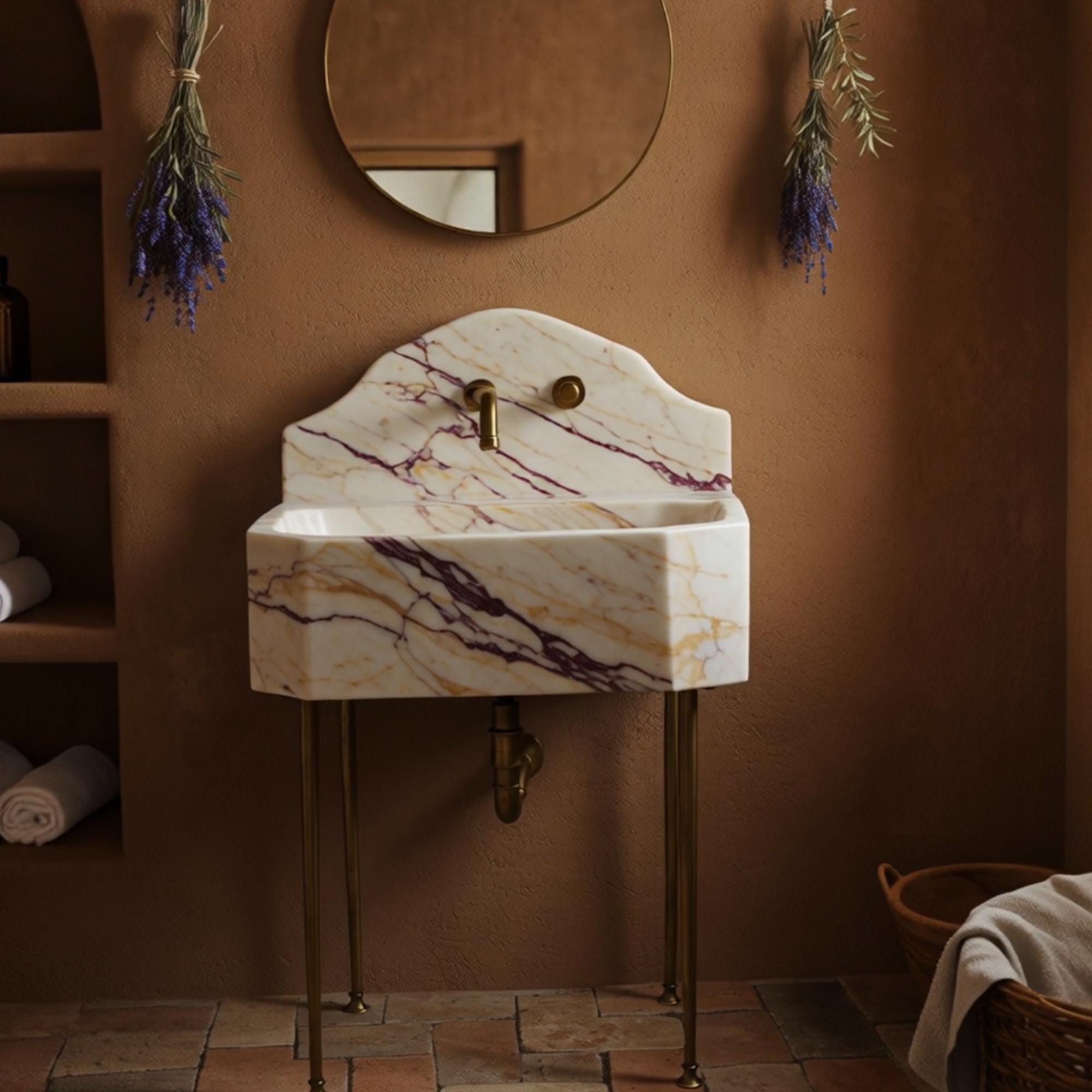 Wall-mounted corner vanity in Calacatta Amber Viola marble with high backsplash and brass fixtures.