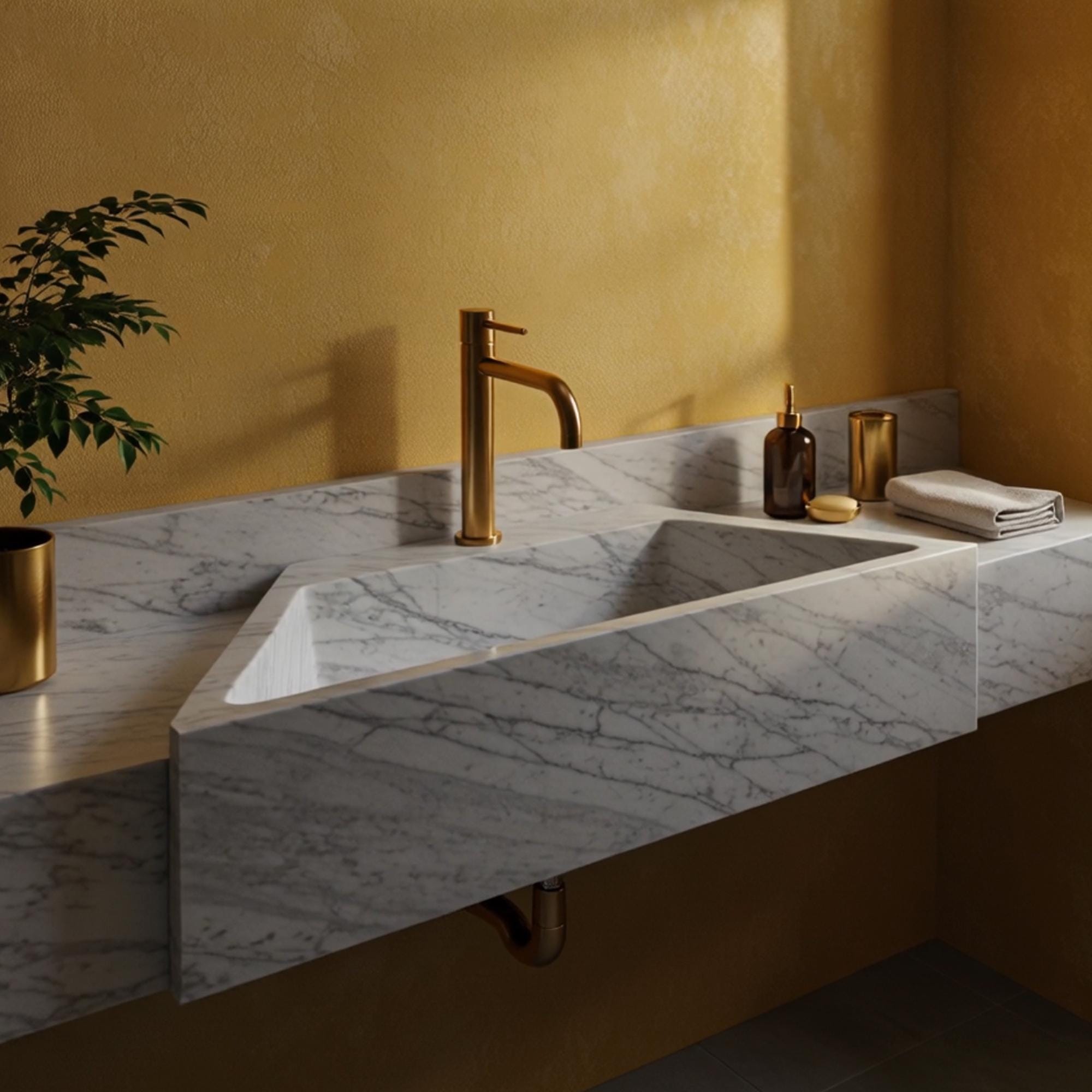 Wall-mounted Carrara marble sink featuring a minimalist form with sculpted backsplash.