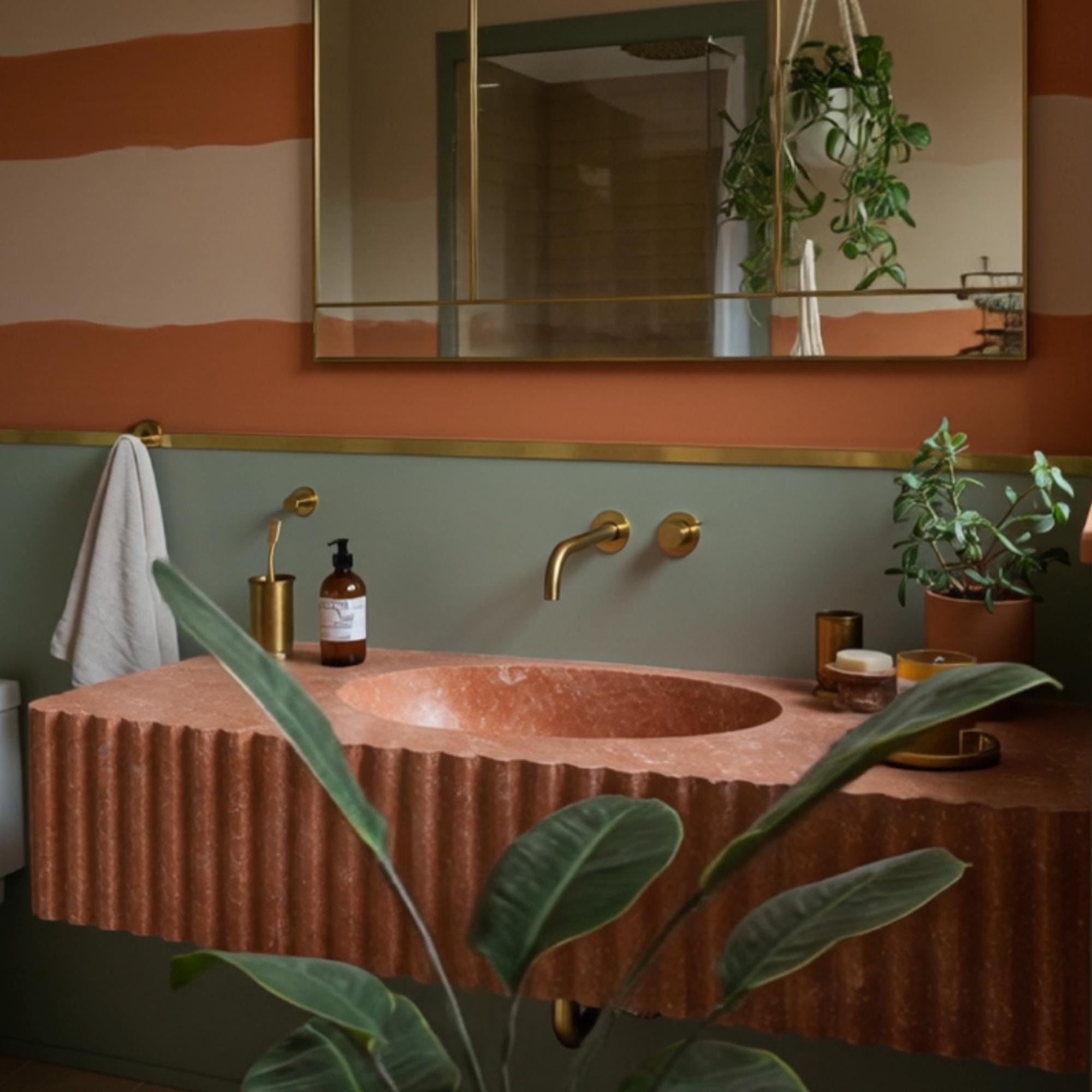 Modern bathroom sink in floating design, made from red travertine with sculpted fluted detailing.
