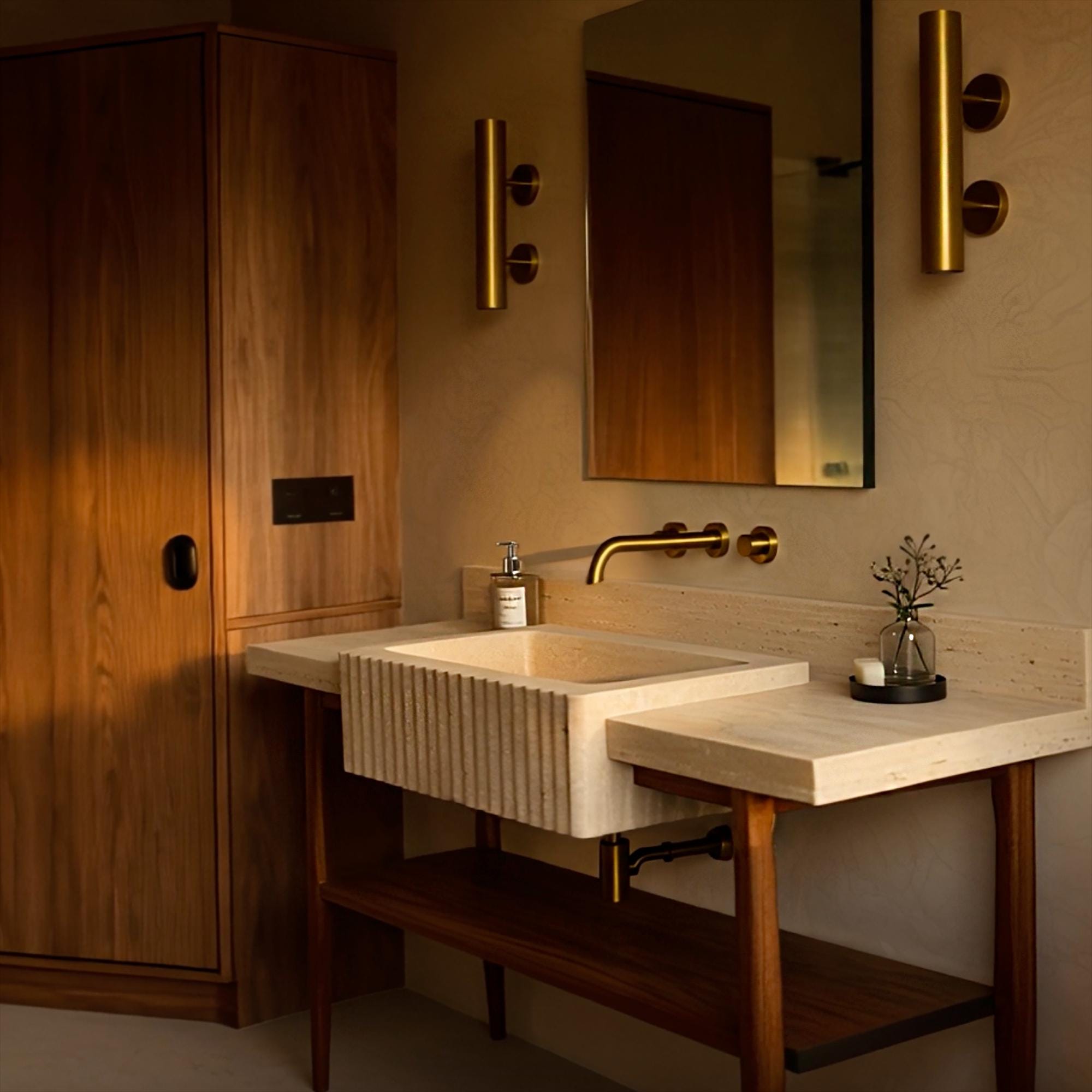 Natural beige travertine sink with fluted front, elegant oak base, and a minimalist integrated backsplash.