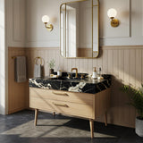 Nero Marquina marble vanity with integrated basin and mid-century style natural wood cabinet.