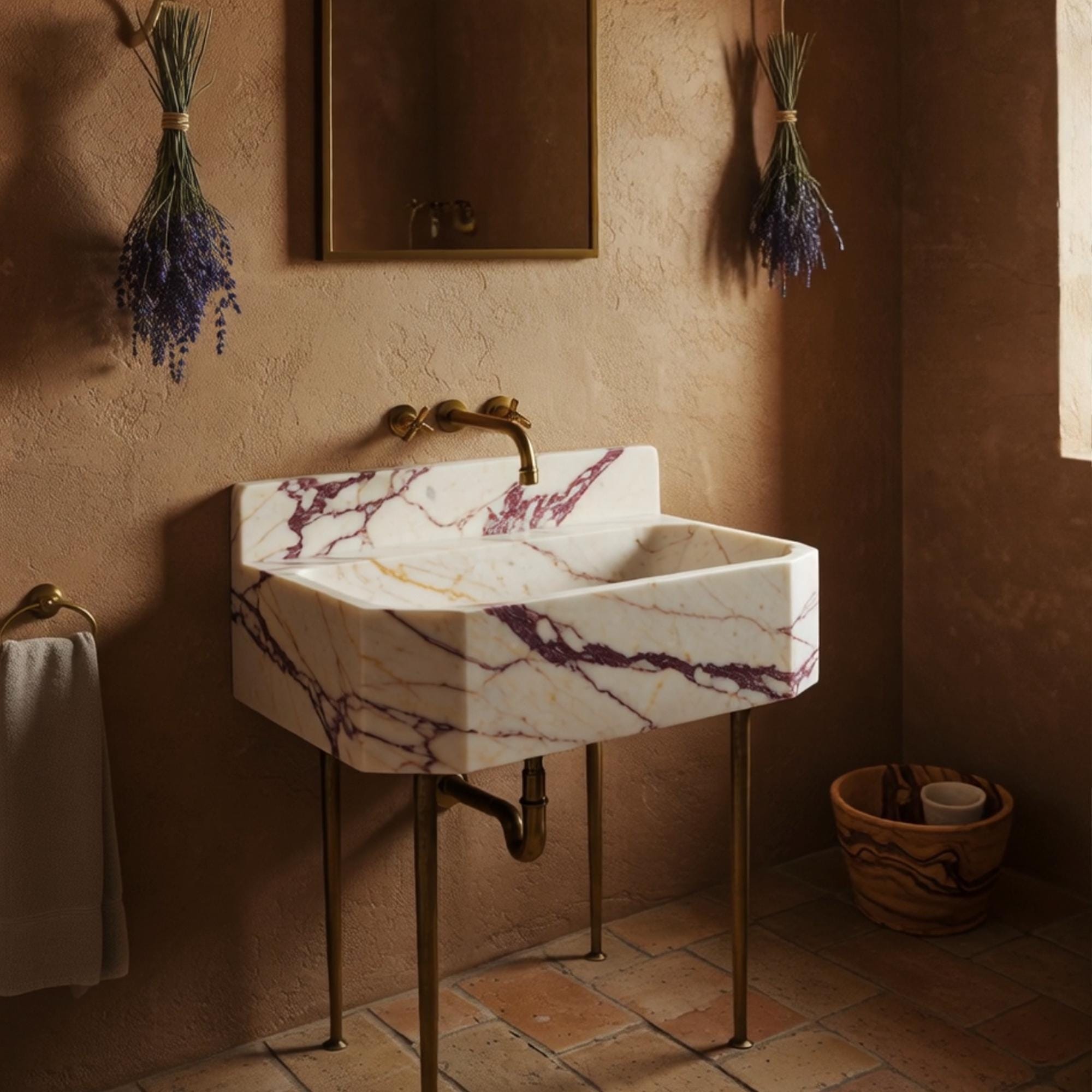Octagonal marble sink in Calacatta Amber Viola with elegant brass console and high backsplash.