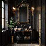 Pietre Notte black marble console vanity with gold-tipped legs and open storage shelf.