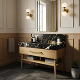 Black Pietre Notte marble vanity top with integrated backsplash, natural wood console and open shelf storage.
