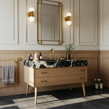 Pietre Notte marble vanity with integrated basin and mid-century style wooden cabinet featuring brass handles.