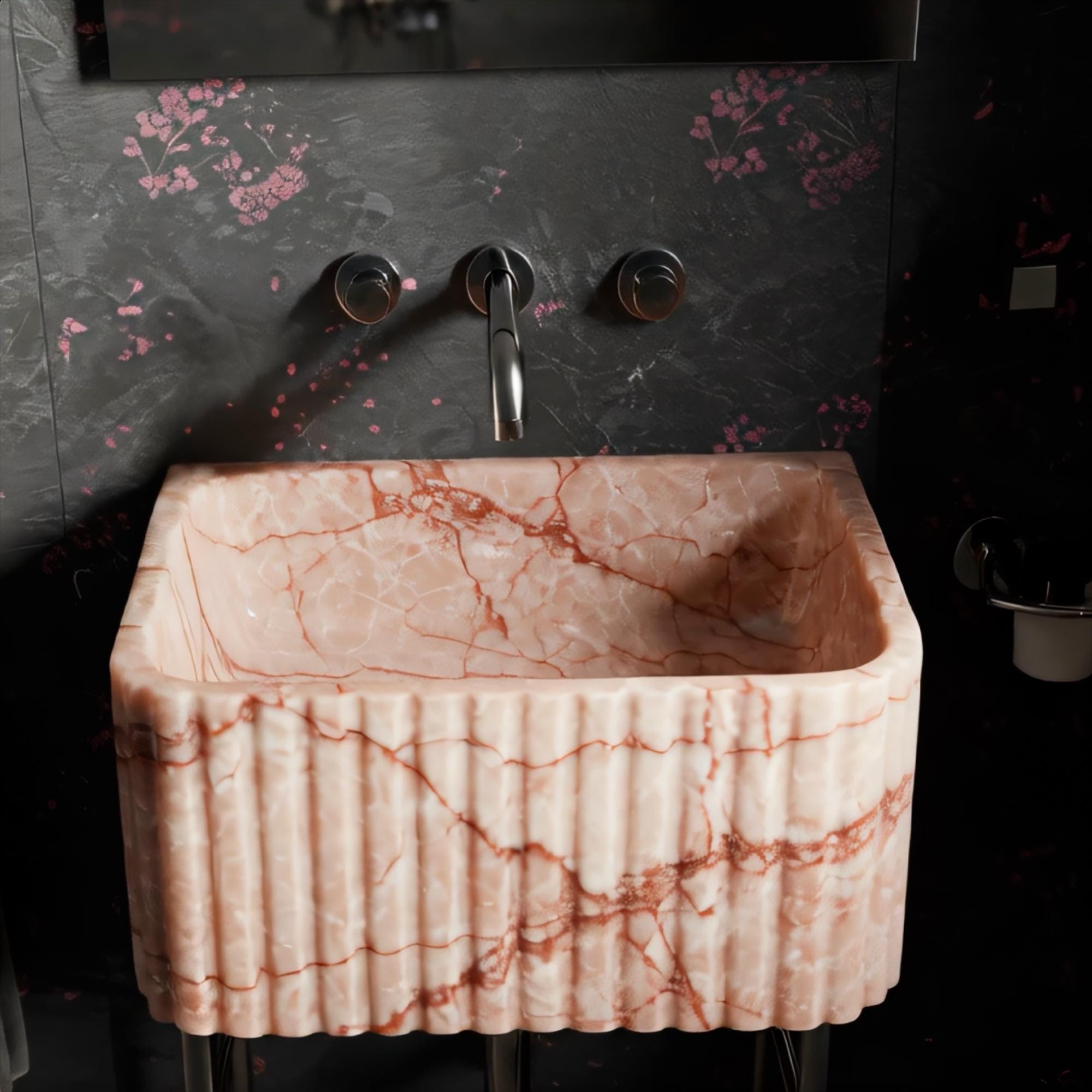 Modern fluted washstand in rich pink marble on sleek stainless steel pedestal legs.
