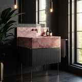 A luxurious pink marble fluted sink paired with a black ribbed storage cabinet, blending style with functionality.