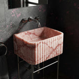 Chic and compact pink marble fluted washstand perfect for stylish powder rooms.