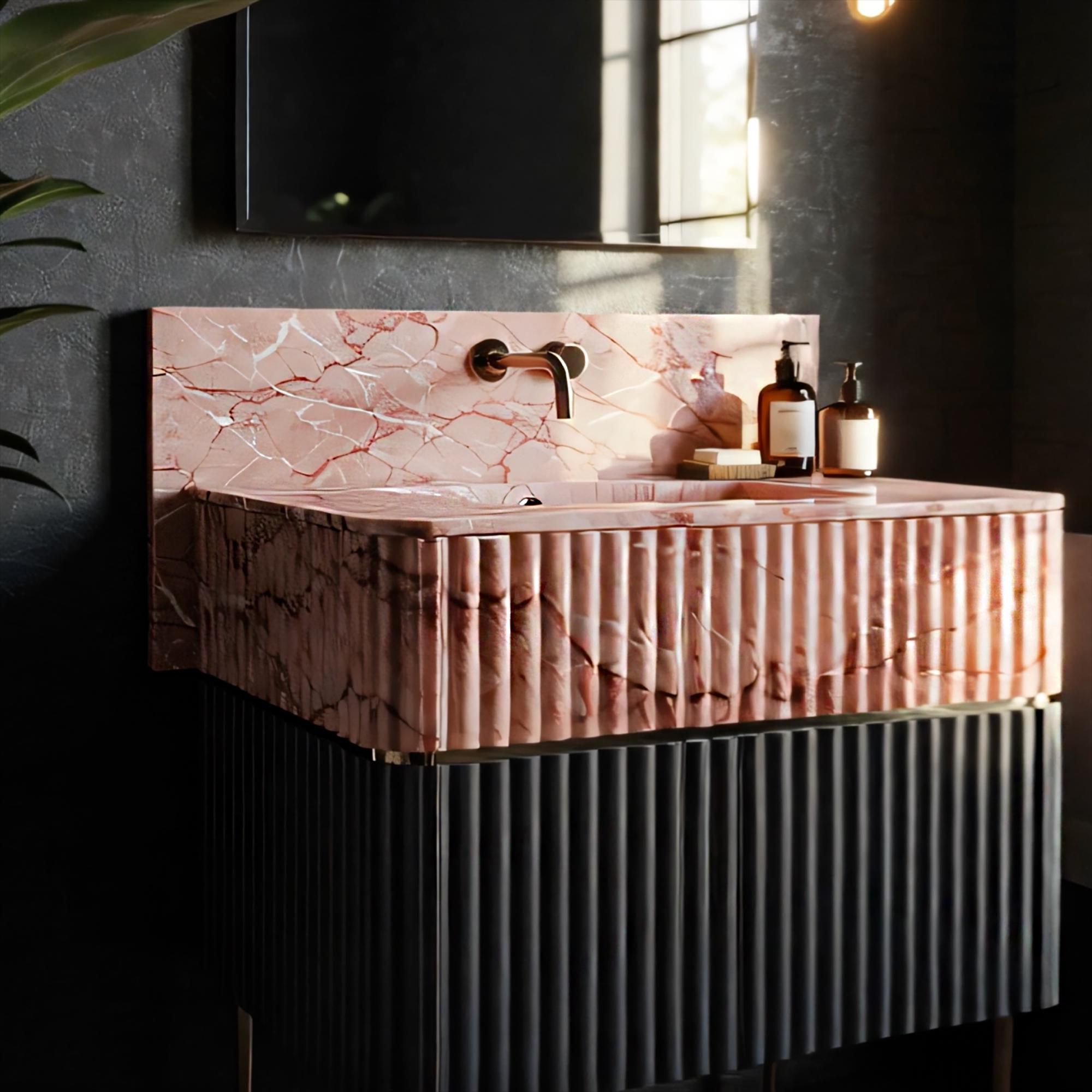 Modern rose marble sink with fluted details atop a sleek black ribbed cabinet, perfect for contemporary bathrooms.