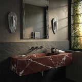 Rosso Levanto red marble floating sink with sharp geometric lines, wall-mounted for a bold modern aesthetic.