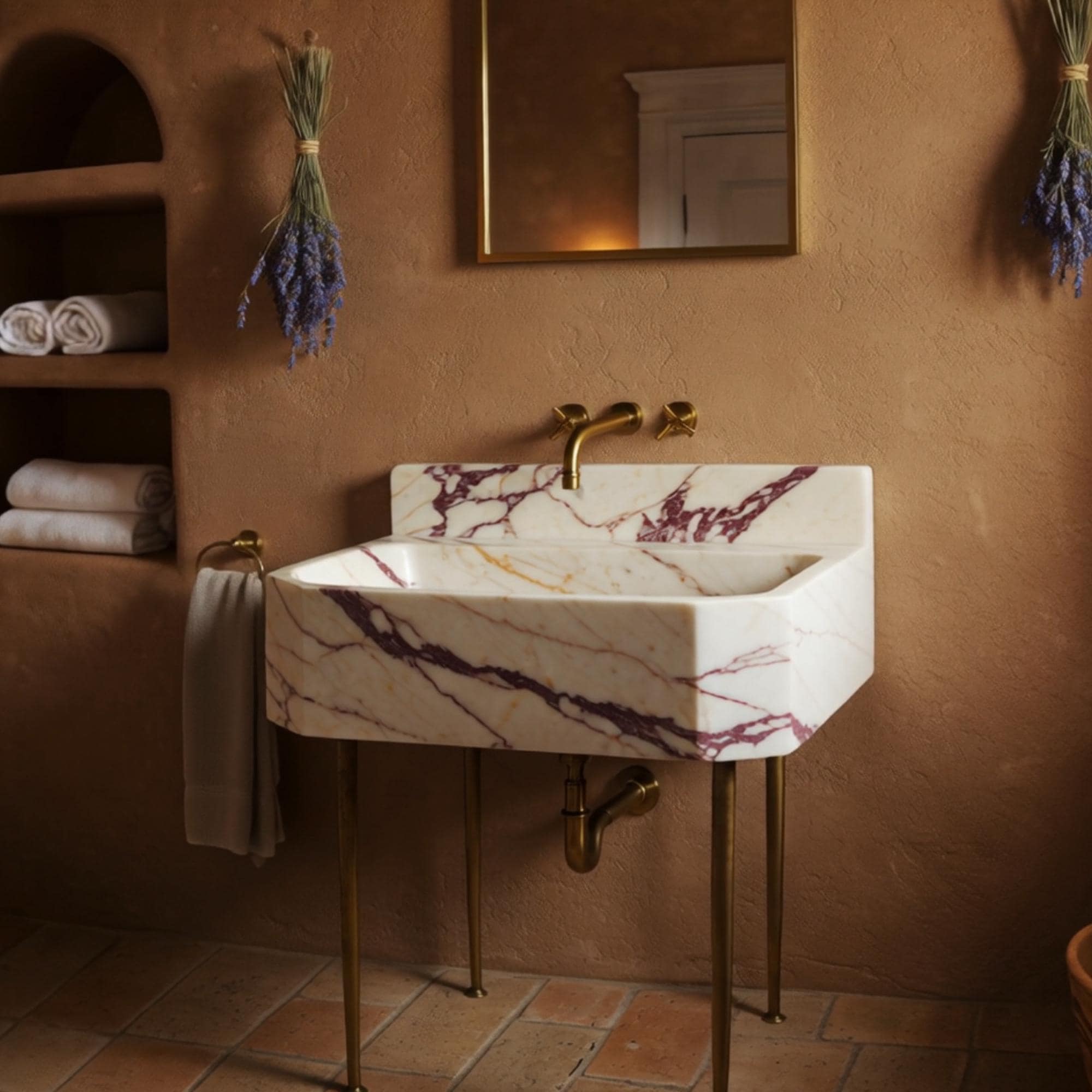 Vanity sink in white marble with violet and gold veining, paired with minimalist brass legs.