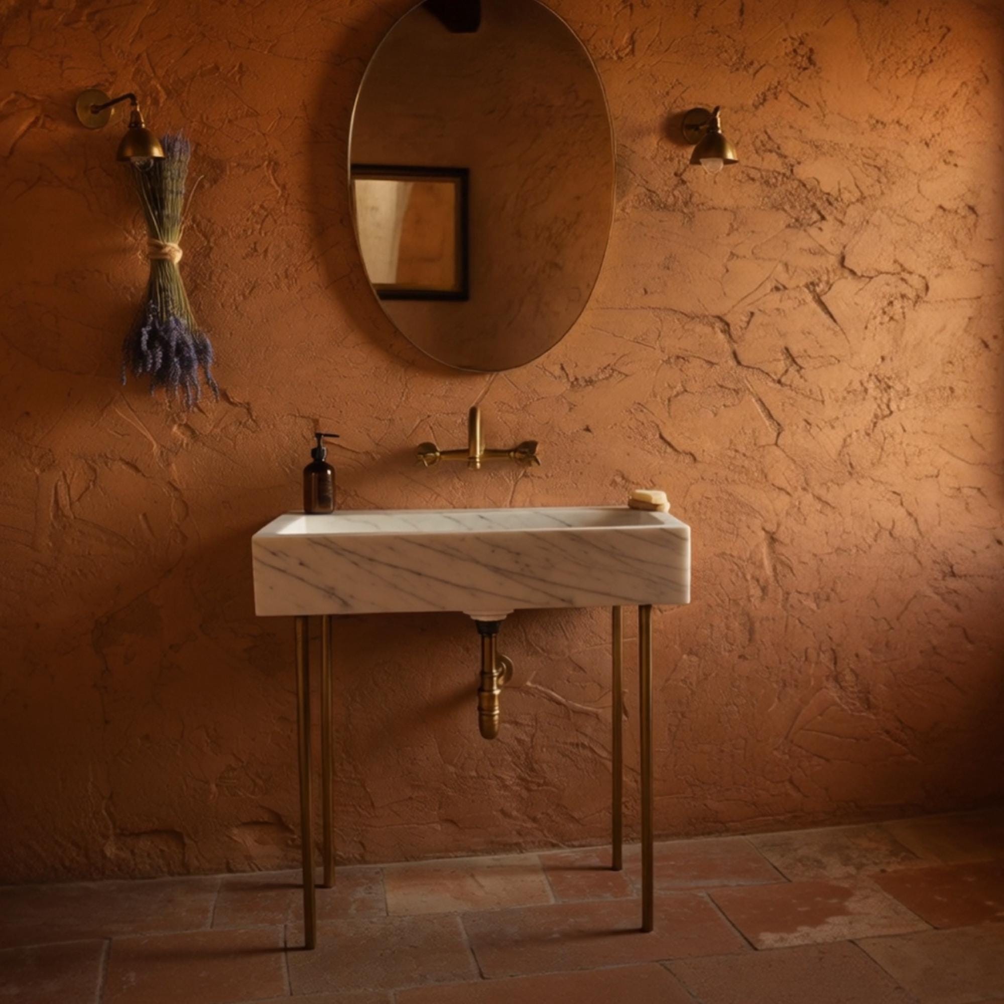 Elegant slim Carrara marble wall-mounted sink featuring a minimalist silhouette and metal base.